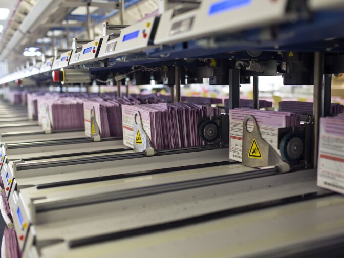 Vote-by-mail ballots are sorted into their appropriate district after arriving at the Los Angeles County Registrar/Recorder building in Norwalk on Friday, Oct. 17. The earliest-arrivng mail-in ballots are the first to be counted after the 8 p.m. poll-closing time.