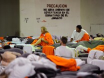 Inmates at Chino State Prison, which houses 5500 inmates, crowd around double and triple bunk beds in a gymnasium that was modified to house 213 prisoners on December 10, 2010 in Chino, California.