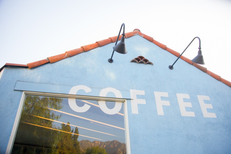 The side of a building that says "coffee" on it.