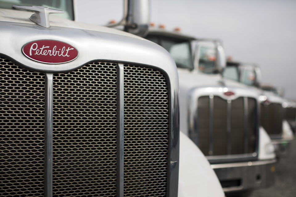 Peterbilt 384 liquefied natural gas trucks are in line to be auctioned off at Ritchie Bros. Auctioneers in Perris, Calif. on Friday, Dec. 9, 2016. 