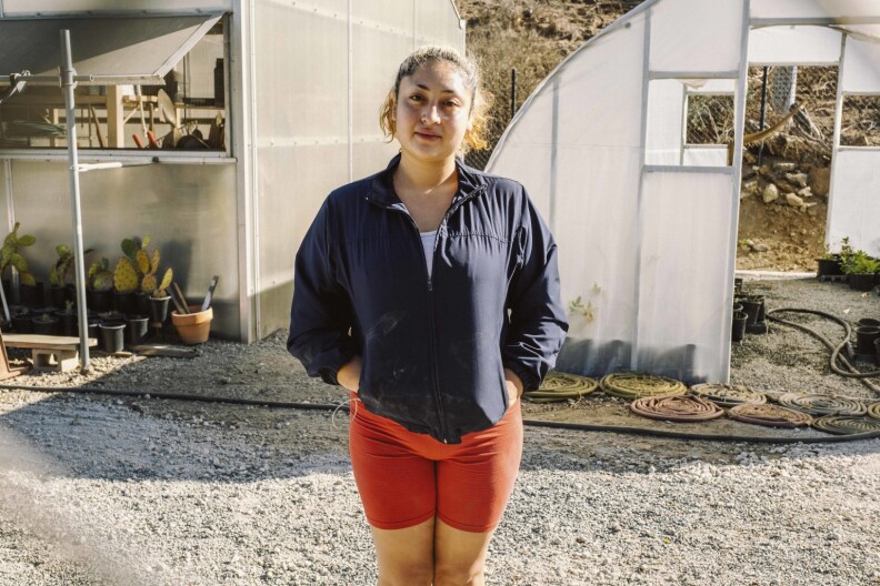Ingrid Carrillo tends to the native plants at the educational greenhouse