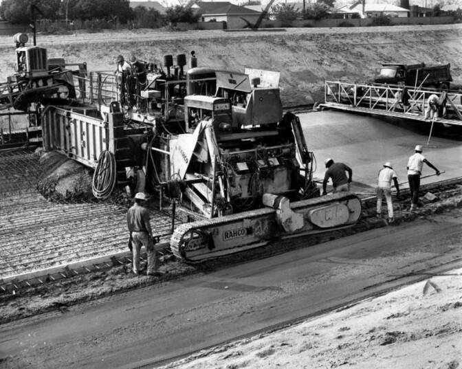 A crew of men are seen paving the main channel, San Gabriel's water flood control project. It is near Whittier Narrows and is part of the county's multi-million dollar effort to prevent inundations. Photo dated: November 8, 1965.