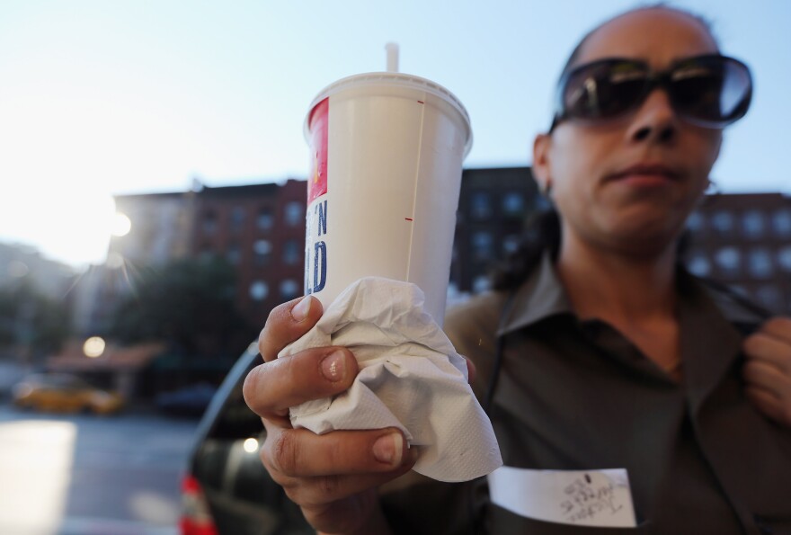 NEW YORK, NY - SEPTEMBER 13:  Jasmine Batista displays a 21-ounce soda she purchased at McDonalds in Manhattan after the New York City Board of Health voted to ban the sale of large sugary drinks at restaurants and concessions on September 13, 2012 in New York City. Batista said once the ban goes in effect she will purchase 2-liter soda bottles from businesses that aren't affected by the ban. Batista said, "I can't stand people telling me what I can drink." The controversial measure bars the sale of sugar drinks larger than 16 ounces in an effort to combat obesity. (Photo by Mario Tama/Getty Images)