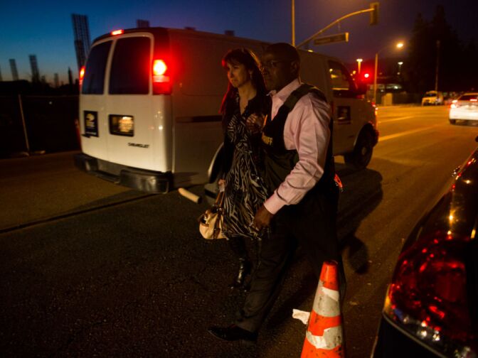 A Sheriff and another woman mourn the loss of a San Bernardino Sheriff's Deputy at Loma Linda Hospital.