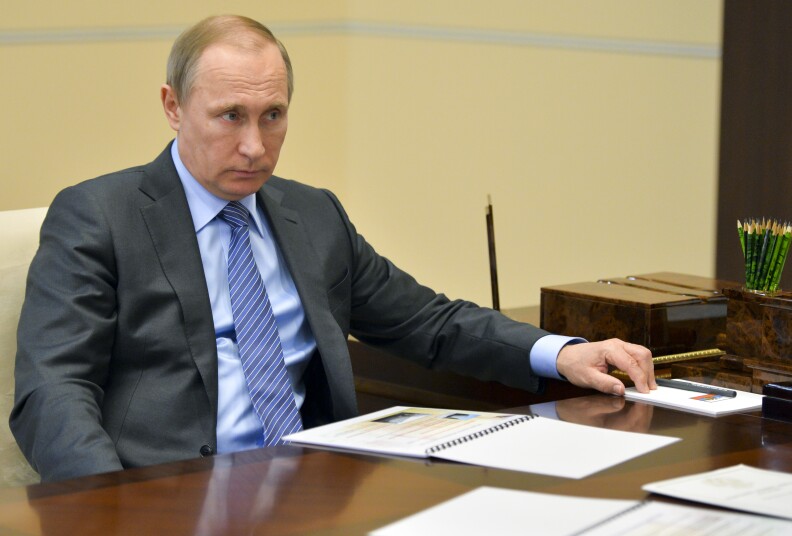 Russian President Vladimir Putin listens during a meeting in the Novo-Ogaryov residence outside Moscow on Monday, April 4, 2016.  The spokesman for Russian President Vladimir Putin, Dmitry Peskov has dismissed suggestions of Putin's involvement in an offshore account scheme as a smear likely motivated by "Putinophobia." (Alexei Druzhinin/Sputnik, Kremlin Pool Photo via AP)