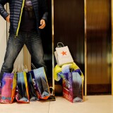 NEW YORK, NY - NOVEMBER 25:  A shopper waits inside a Macy's store during Black Friday events on November 25, 2016 in New York City.  The day after Thanksgiving, called Black Friday, is typically the biggest shopping day of the year in the United States. (Photo by Eduardo Munoz Alvarez/Getty Images)