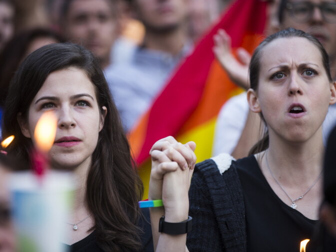 Kassandra Shore, left, and Candice Darden of Studio City attend a vigil on Monday, June 13, 2016 at Los Angeles City Hall memorializing those who died in Sunday's attack in Orlando.