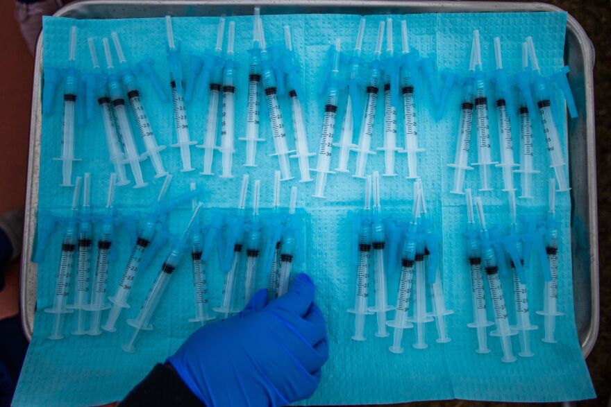 A nurse takes a Moderna Covid-19 vaccines ready to be administered at a vaccination site at Kedren Community Health Center, in South Central Los Angeles, California on February 16, 2021. (Photo by Apu GOMES / AFP) (Photo by APU GOMES/AFP via Getty Images)