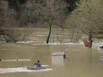 A man uses a rowboat to make his way through a flooded RV park as the Russian River flows in the distance on Jan. 9, 2017, near Forestville, Calif. A massive storm system stretching from California into Nevada lifted rivers out of their banks, flooded vineyards and forced people to evacuate after warnings that hillsides parched by wildfires could give way to mudslides. 