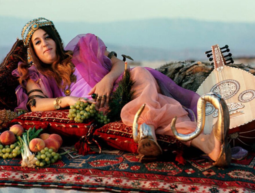 Henry Diltz captured Mama Cass striking this Cleopatra pose. 