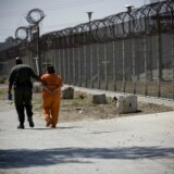 A security guard walks a female inmate at the California Institution for Women in San Bernardino County. 