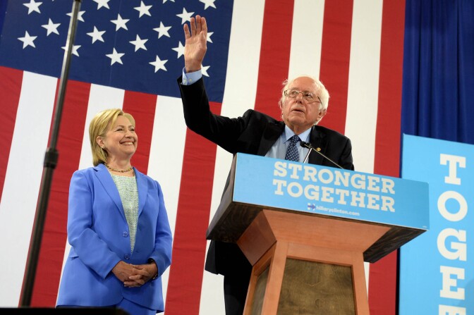 PORTSMOUTH, NH - JULY 12: Bernie Sanders (R) introduces Presumptive Democratic presidential nominee Hillary Clinton at Portsmouth High School July 12, 2016 in Portsmouth, New Hampshire. Sanders endorsed Clinton for president of the United States. (Photo by Darren McCollester/Getty Images)