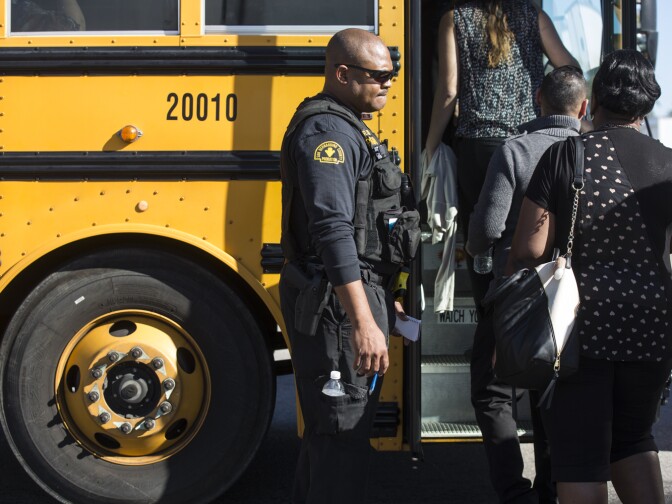 Employees are evacuated from the Inland Regional Center and led into buses following a mass shooting inside the San Bernardino building on Wednesday, Dec. 2, 2015.