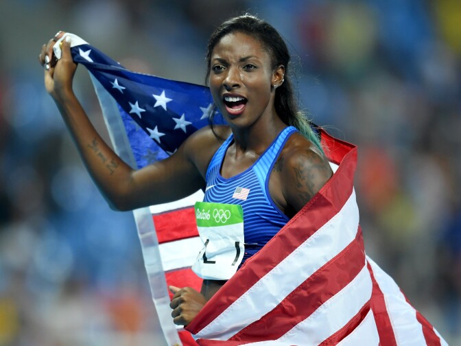 RIO DE JANEIRO, BRAZIL - AUGUST 17:  Nia Ali of the United States celebrates with the American flag after winning the silver medal in the Women's 100m Hurdles Final on Day 12 of the Rio 2016 Olympic Games at the Olympic Stadium on August 17, 2016 in Rio de Janeiro, Brazil.  (Photo by Matthias Hangst/Getty Images)