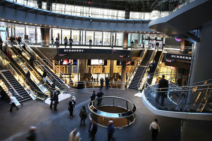 NEW YORK, NY - NOVEMBER 10:  Commuters walk through the newly opened Fulton Center train station in lower Manhattan on November 10, 2014 in New York City.  The station was scheduled to open in 2007 as part of the rebuilding effort of lower Manhattan after 9/11, but the project ran into cost overruns and years of delays. The original plan for the facility, which has a glass and steel shell and 66,000 square feet of retail and office space, was projected at $750 million and nearly doubled to $1.4 billion before it was finished. The station features a 10-foot-high glass opening , or oculus, which sits above an atrium that lets sunlight down into two levels below street level. The station makes it easier to connect between nine subway lines: the A, C, J, Z, R, 2, 3, 4, and 5. Riders will eventually also be able to connect to the E and 1 trains, as well as the PATH.  (Photo by Spencer Platt/Getty Images)