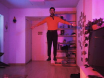 A man bathed in pink light floats above the floor in the short Trips, Friends, Night & Destiny (Los viajes, los amigos, la noche y el destino),