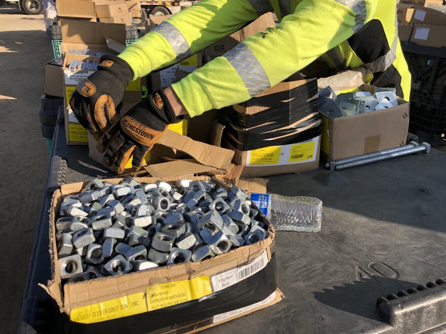 An Edison worker prepares materials used in fixing and replacing electrical equipment across the Malibu burn areas.