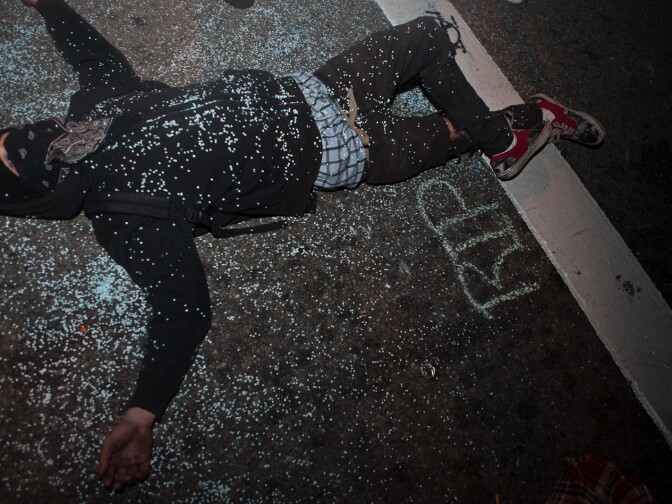 An Occupy Los Angeles protester lay in the middle of First Street as he waited for police to arrive and the raid to begin.
