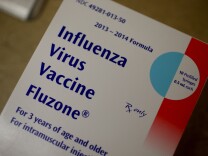 A box of influenza vaccine shots is seen in the MinuteClinic at the CVS/pharmacy on January 6, 2014 in Fort Lauderdale, Florida. The 2013-2014 influenza season is starting to take off in the United States, with more than half the country reporting widespread cases of flu activity, according to the US Centers for Disease Control and Prevention.   