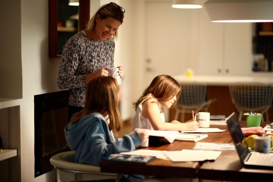 SAN ANSELMO, CALIFORNIA - MARCH 18:  Daisley Kramer helps her daughters, sixth grader Frances (left) and fourth grader Lucy, with schoolwork at home on March 18, 2020 in San Anselmo, California. The schools that the girls attend are both closed because of COVID-19. California Governor Gavin Newsom warned yesterday that schools are unlikely to reopen in the coming weeks and will more than likely remain closed until the summer break.  (Photo by Ezra Shaw/Getty Images)