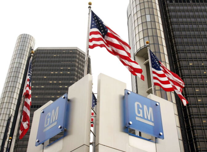 DETROIT - NOVEMBER 18:  Signs stand in front of the General Motors world headquarters complex November 18, 2010 in Detroit, Michigan. GM returned to selling its newly issued stock to the public today as they resumed trading on the NYSE. The stock sales are expected to generate approximately $23 billion for General Motors.  (Photo by Bill Pugliano/Getty Images)