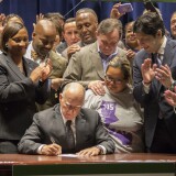 LOS ANGELES, CALIFORNIA - APRIL 04:  California Governor Jerry Brown signs landmark legislation SB 3 into law on April 4, 2016 in Los Angeles, California. The law makes California the first state in the nation to commit to raising the minimum wage to $15 per hour statewide. (Photo by David McNew/Getty Images)