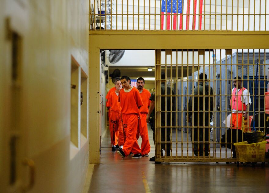 Gov. Jerry Brown is changing tactics as a way to reduce prison overcrowding. Brown is now seeking to move prisoners to private cells out of state as an alternative to releasing thousands of prisoners early. (Photo: Inmates at Chino State Prison walk the hallway on December 10, 2010 in Chino, California). 