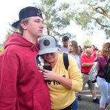People react near Central Park after a shooting at Saugus High School in Santa Clarita, California on November 14, 2019. - At least four people were injured in a shooting at a high school north of Los Angeles Thursday, triggering a police hunt for the suspect who was later taken into custody.One female was killed Thursday, hospital officials said. The suspect was in custody and taken to a hospital for treatment, while at least three others were injured in the shooting at Saugus High School in Santa Clarita, 40 miles (65 kilometers) north of Los Angeles."One female deceased patient. Two critical male patients. One male patient in good condition," tweeted the nearby Henry Mayo Hospital in Valencia.No further details of the deceased were provided. (Photo by Frederic J. BROWN / AFP) (Photo by FREDERIC J. BROWN/AFP via Getty Images)