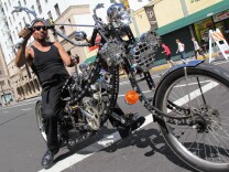Art "Chopper" Ramirez rides down 9th Street on his customized bike at L.A.'s third CicLAvia event on October 9, 2011.