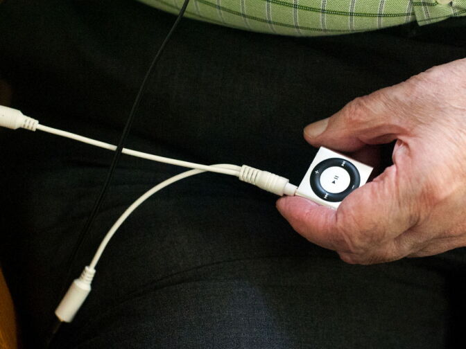 Tom H. holds one of fifty iPod Shuffles that Atherton received as one of 15 facilities that were part of the pilot Music & Memory project. Atherton raised funds for the program which were then matched by a grant.