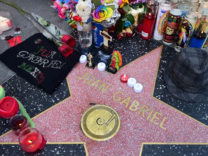 A display of flowers, candles, wreaths and other mementos placed in honor of the late Mexican music icon Juan Gabriel at his Star on the Hollywood Walk of Fame on August 29, 2016 in Hollywood, California.