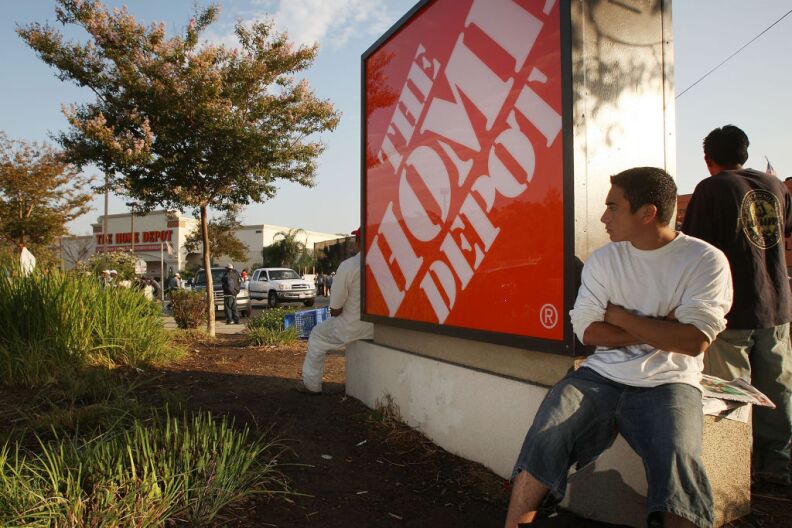 Day laborers wait near a Home Depot home improvement store in hope of finding work for the day on August 15, 2008 in Los Angeles, California. The Los Angeles City Council has unanimously approved an ordinance requiring some big-box stores to develop plans to manage dayworkers who gather nearby for employment. Under the new law, companies such as Home Depot and Lowe's may be forced to build day-labor centers with drinking water, shelter, restrooms, and trash cans at stores of 100,000 square feet or more if significant numbers of day laborers are in the area. Employers of the workers typically drive up to a group of workers, quickly negotiate a deal, and within moments selected workers get into the vehicle and are taken to the job site. Much of the work is done for construction and landscaping employers who buy some of their supplies at such stores. Some work comes from do-it-yourself homeowners. 
