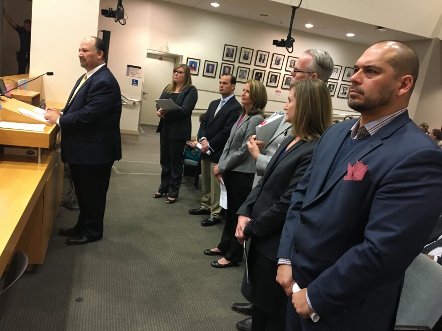Members of a working group of Los Angeles Unified School District officials and charter school leaders stands before the district's school board on Tues., April 3, 2018.