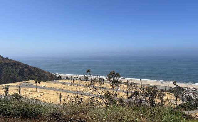 A shot of empty dirt lots of a former mobile home park overlooking the Pacific Ocean in Pacific Palisades on a sunny day. 