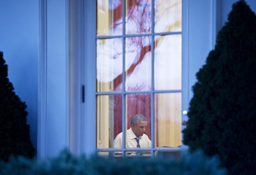 US President Barack Obama works in the Oval Office of the White House on January 27, 2014 in Washington, DC. Obama is due to deliver his 2014 State of the Union address on January 28. 