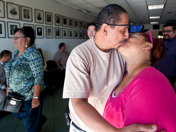 Jimmy Vasquez and Rosalie Martinez-Vasquez of Long Beach kiss in the lobby of the LA County Registrar-Recorder’s office, as they wait to be married on Monday after three years. The couple will also do a church ceremony in the near future.
