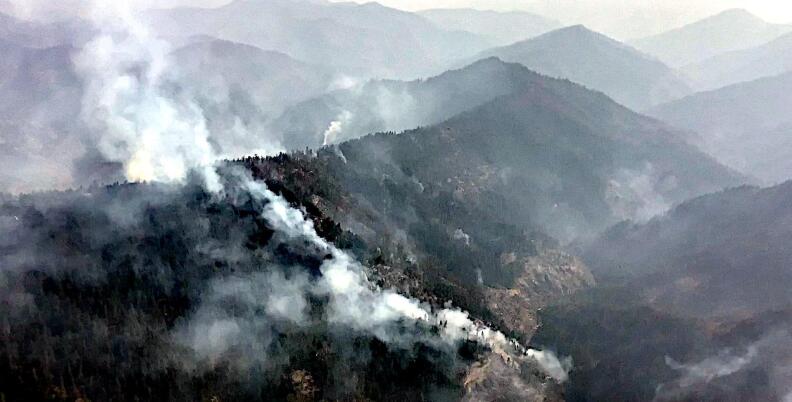 Smoke over the ridge of a mountain