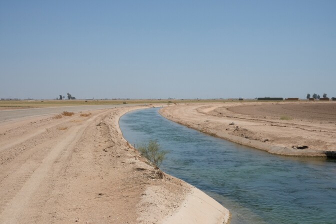 A canal of Colorado River water runs through dry fields amid 115 degree temperatures in the Imperial Valley of southern California on July 22, 2024. 