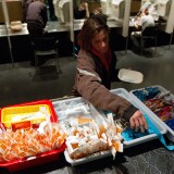 TO GO WITH AFP STORY by Laurent VU THE, Canada-society-drugs-health
A client of the Insite supervised injection Center in Vancouver, Canada, collects her kit on May 3, 2011. The Canadian Supreme Court is to settle a conflict between the government's wishes to close the center and the center's success in fighting the spread of AIDS among drug addicts. In eight years of existence, and with more 600 visits per day on average, Insite believes it has made advances in the fight against AIDS. And in a radius of 500 meters around the center, deaths by overdose dropped by 35 percent since the opening, according to a study published in the medical newspaper The Lancet.    AFP PHOTO/Laurent Vu The (Photo credit should read Laurent Vu The/AFP/Getty Images)