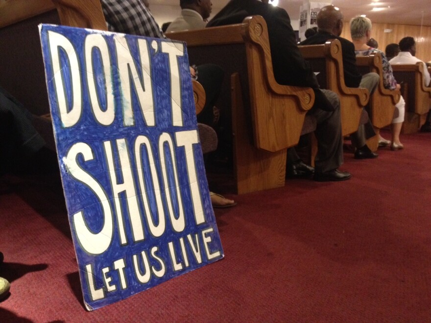 People sit in the pews at Paradise Baptist Church in South LA. LAPD Chief Charlie Beck addressed a community meeting about the fatal police shooting of Ezell Ford.