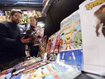 File: Joe and Kristy Isenbergh, of Boston, browse a selection of free comics at Newbury Comics in Boston, Saturday, May 5, 2012.