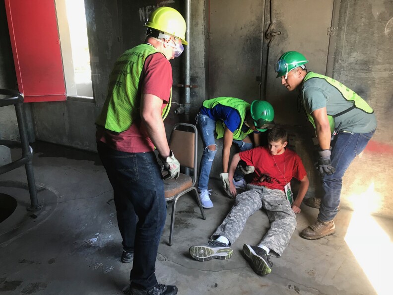 CERT trainees find Christian Smith and carrying him out of the building to safety and medical help at the triage center they have set up. Photo credit: Audrey Alden