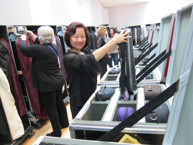 Members of the L.A. Philharmonic unpack their instruments after arriving in Tokyo.
