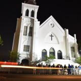 People pay their respects outside Emanuel AME Church in Charleston, South Carolina on June 18, 2015.  Police captured the white suspect in a gun massacre at one of the oldest black churches in the United States, the latest deadly assault to feed simmering racial tensions. Police detained 21-year-old Dylann Roof, shown wearing the flags of defunct white supremacist regimes in pictures taken from social media, after nine churchgoers were shot dead during bible study   on June 17, 2015. AFP PHOTO / MLADEN ANTONOV        (Photo credit should read MLADEN ANTONOV/AFP/Getty Images)