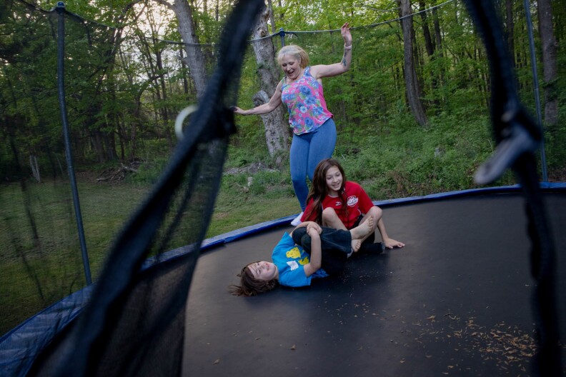 Linda Munson, 56, jumps on a trampoline in her yard with her grandchildren, Christopher Gomez, 8, (left) and Andrew Gomez, 11. "I have so much more energy," Munson says.