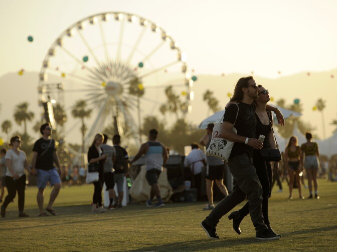 Coachella festivalgoers walk through the Empire Polo Field on the third day of the 2014 Coachella Music and Arts Festival on Sunday, April 13, 2014, in Indio, Calif. (Photo by Chris Pizzello/Invision/AP)