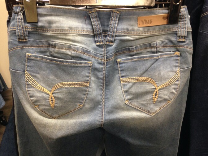The deflated cheeks of an empty pair of "Wanna Betta Butt?" jeans, manufactured by YMI Jeans, Inc. In Boyle Heights. The jeans are inspired by a South American style known as "levanta cola," which translated to "butt lifter." The style is cut in a way that lets one's rear end stand out.