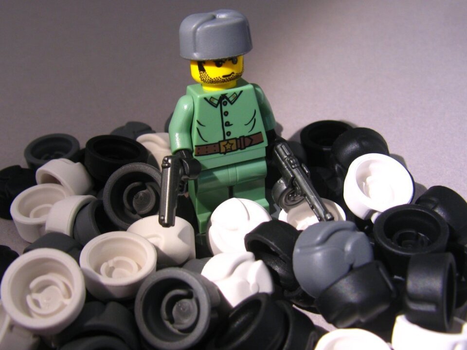 This figure is wearing the BrickArms Ushanka (Russian hat), and holding the BrickArms TT-33 pistol and PPSh submachine gun. The uniform is a Lego design from the Indiana Jones Lego series.