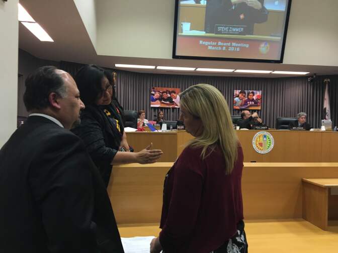 L.A. Unified school board member Mónica García (center) speaks with Shawna Draxton (right), executive director of WISH Charter Schools, as the head of the district's Charter Schools Division, José Cole-Gutiérrez, looks on during a meeting of the board on March 8, 2016. García was working on a motion to overrule district staff and grant WISH's application to open a new charter school despite the misgivings of Cole-Gutiérrez and other board members.