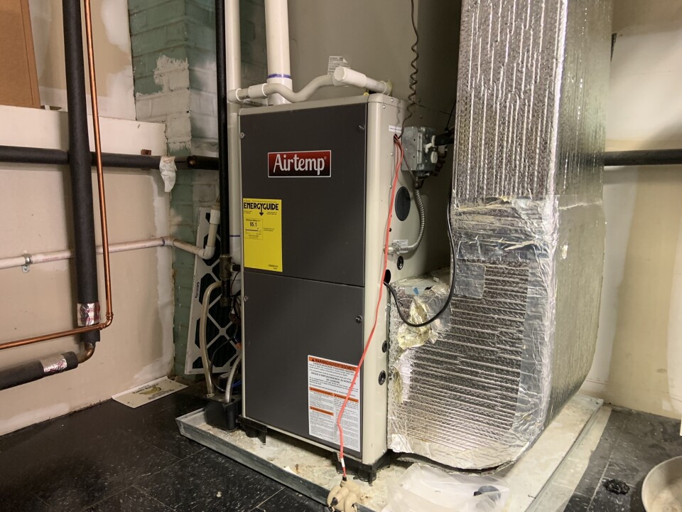 A shot of a condensing furnace in a home.